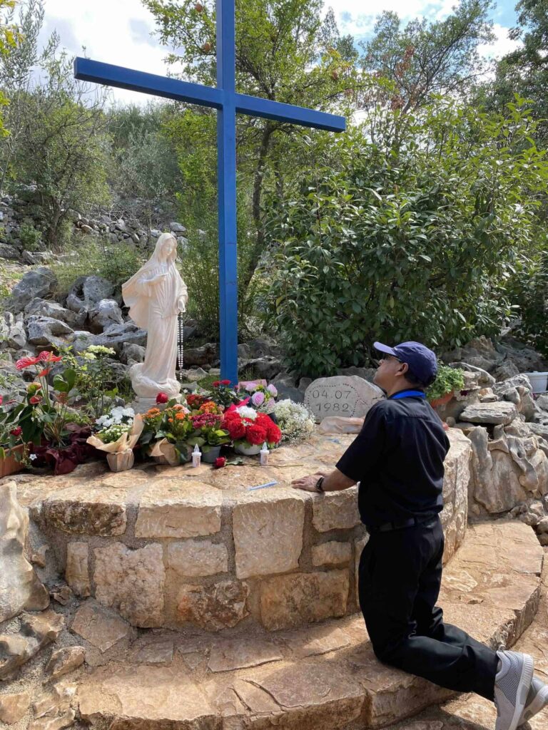 blue-cross-medjugorje-pilgrimage-praying praying at the blue cross on Medjugorje pilgrimage