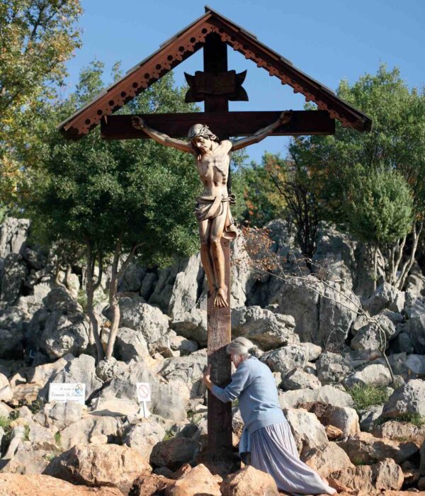 medjugorje-cross Medjugorje woman kneeling at cross on pilgrimage tour