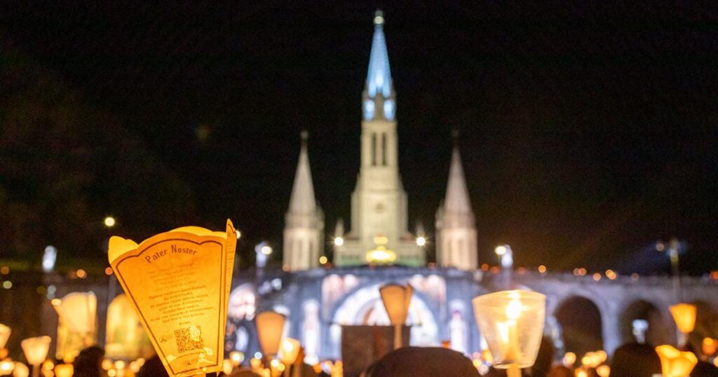 candlelight procession during pilgrimage to Lourdes France. catholic journeys Lourdes pilgrimage