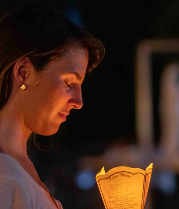 woman-candle-lourdes woman with candle at lourdes pilgrimage tour
